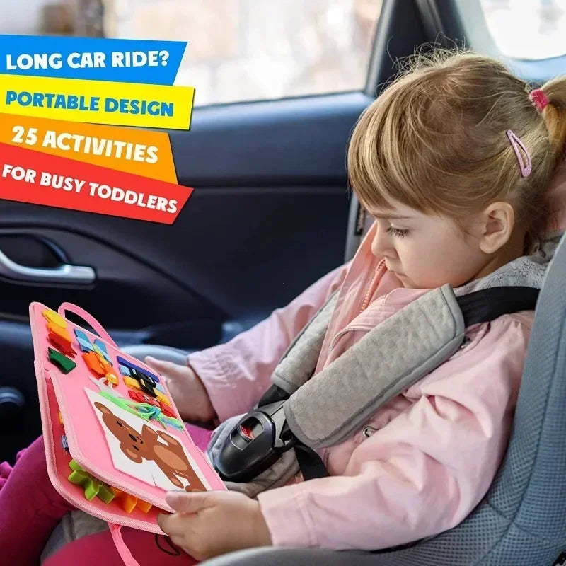 Toddler playing with a felt busy book in a car seat