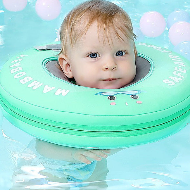 Baby floating in a green Mambobaby neck float, chin and ears clear of the water