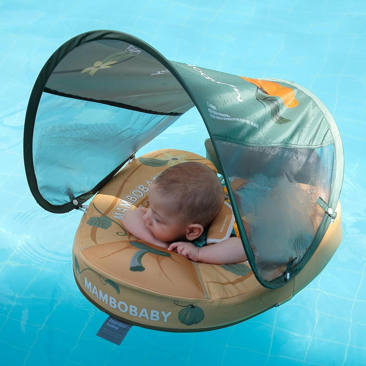 Baby lying on their front in the Mambobaby Pumpkin float with the canopy up